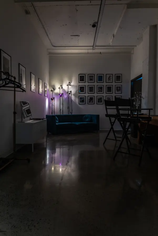 Green room with a blue sofa and makeup stations